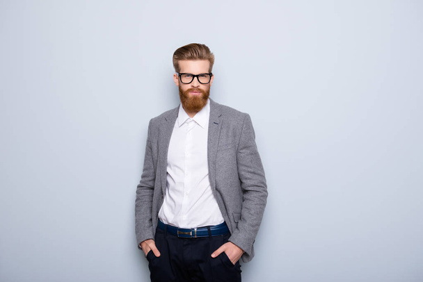 Young handsome man in formalwear with red beard and glasses hold - 写真・画像