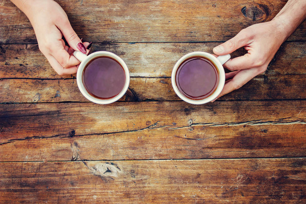 Tea in hand. The lovers are together. Selective focus.  - Photo, Image