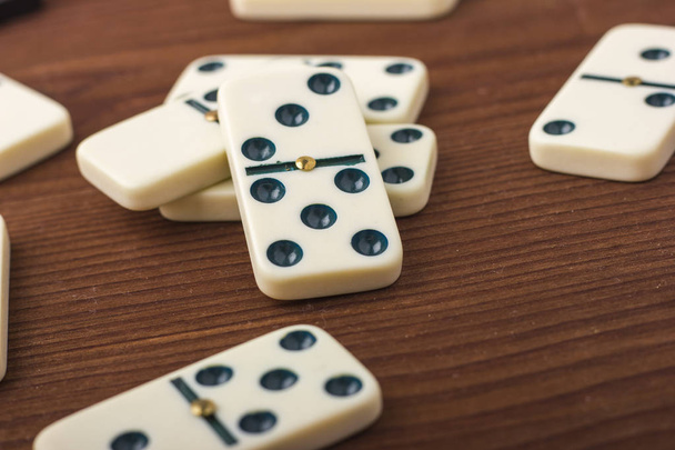 Dominoes are black and white. On a wooden background.  - 写真・画像
