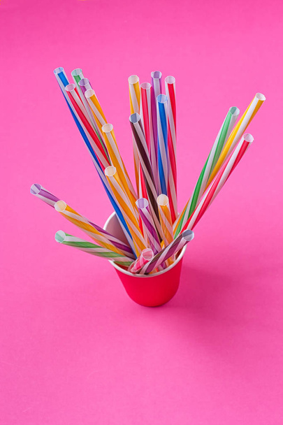 a bundle of multi-colored drinking straws in a paper Cup - Photo, Image
