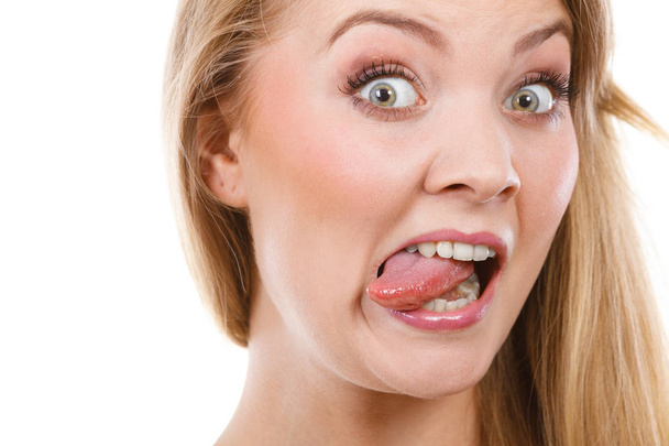 Funny blonde woman sitcking tongue out - Valokuva, kuva