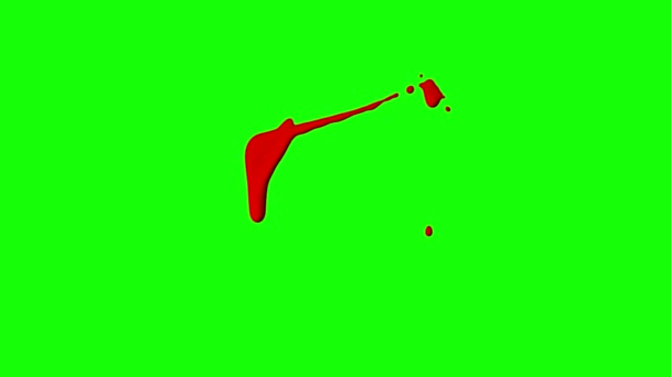 Červený inkoust kape přes zelené pozadí - Záběry, video