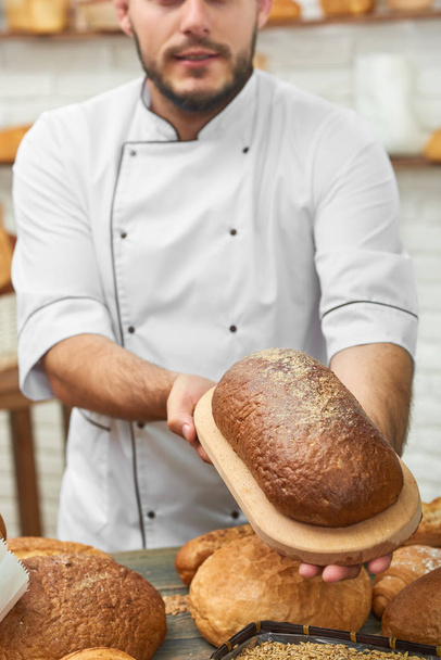 Professional baker working at his kitchen - Zdjęcie, obraz