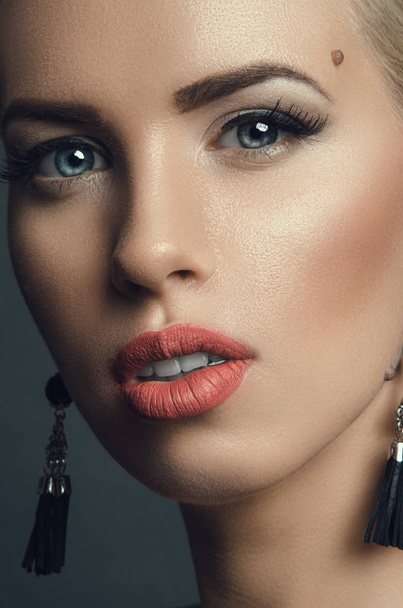 fashion studio portrait of young beautiful woman in earrings - Фото, изображение
