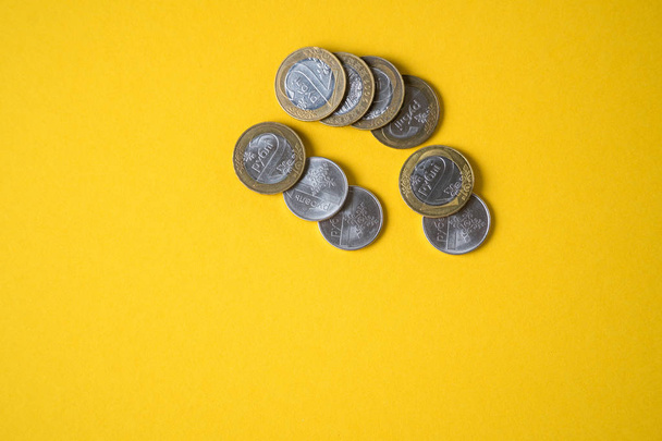 Coins close-up on a yellow background - Foto, Imagem