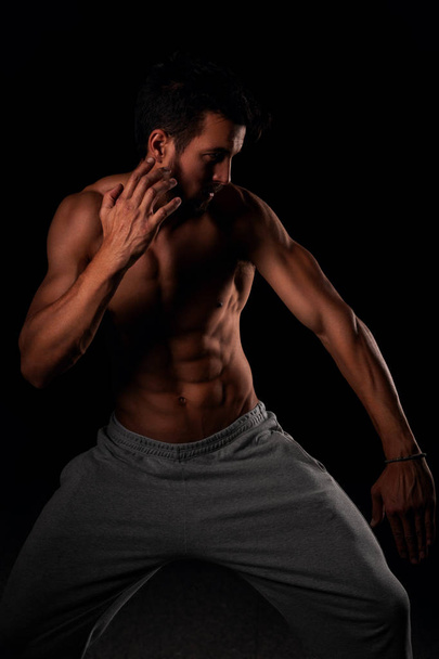 Attractive muscular model posing in fighting position - Foto, Imagem