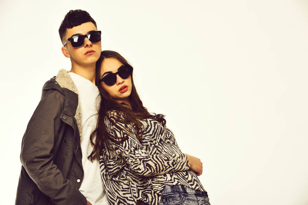 couple of pretty girl and young guy in fashionable sunglasses - Fotó, kép