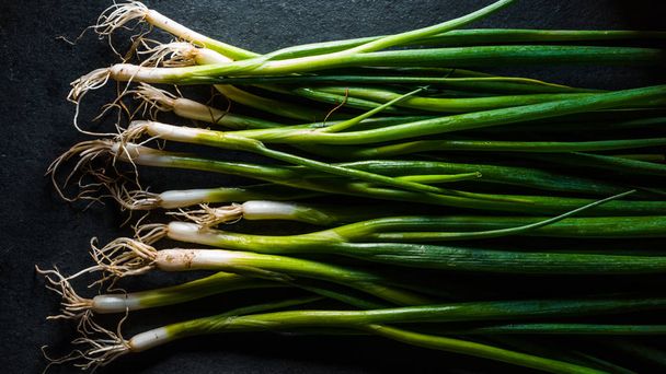 Harvest of green onions on the table surface - Foto, imagen