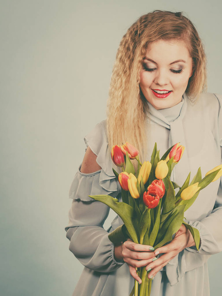 Pretty woman with red yellow tulips bunch - Fotografie, Obrázek