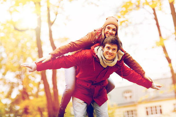 happy young couple having fun in autumn park - Photo, Image