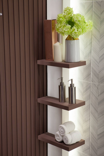 Metal liquid soap bottleon wooden shelf and Towels Bathroom acce - Photo, Image