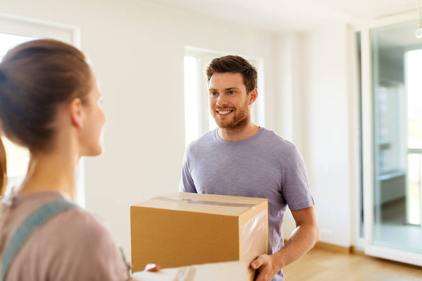 happy couple with boxes moving to new home - Fotoğraf, Görsel