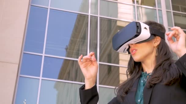 Millennial woman mesmerized by her virtual reality technology outside in slow mo - Imágenes, Vídeo