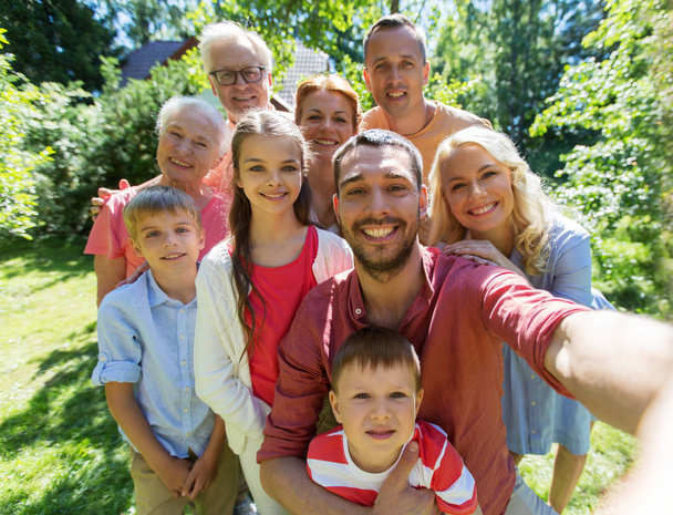 šťastná rodina pořizování selfie v letní zahradě - Fotografie, Obrázek