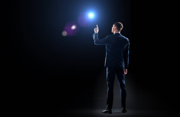 businessman in suit pointing finger to lens flare - Foto, immagini