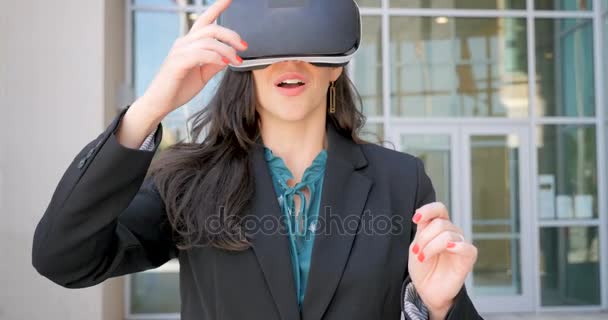 Businesswoman working in virtual reality with VR headset celebrating success - Footage, Video