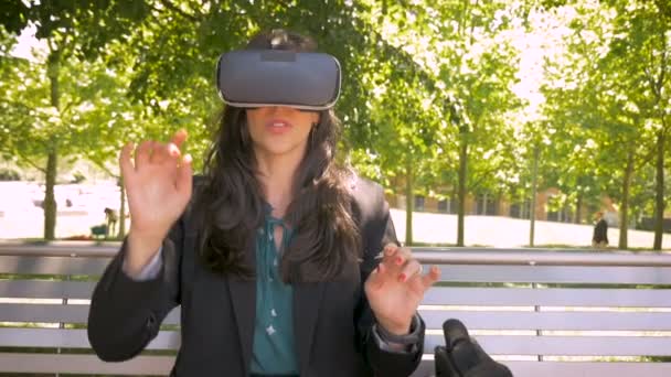 Virtual reality working businesswoman wearing VR headset technology outside - Felvétel, videó