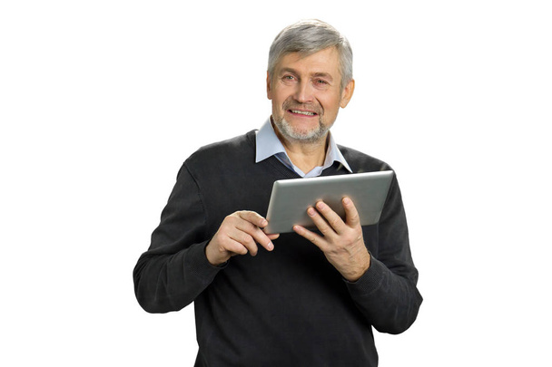 Mature man with tablet looking straight. - 写真・画像