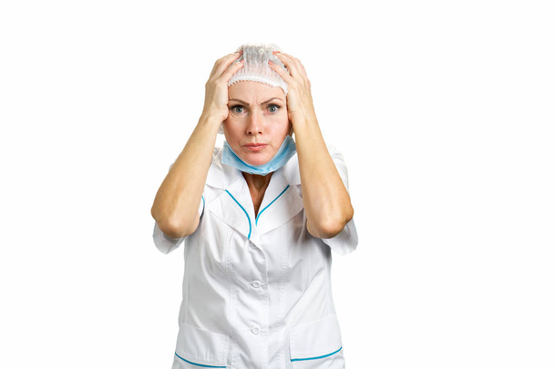 Female doctor shocked with hands on head. - Zdjęcie, obraz