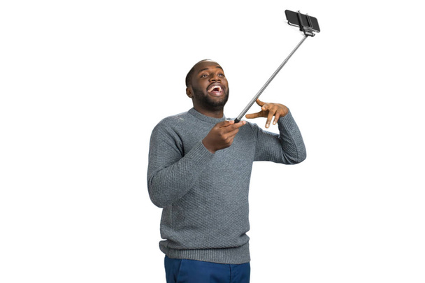 Νεαρός άνδρας λαμβάνοντας selfie φωτογραφία στούντιο. - Φωτογραφία, εικόνα