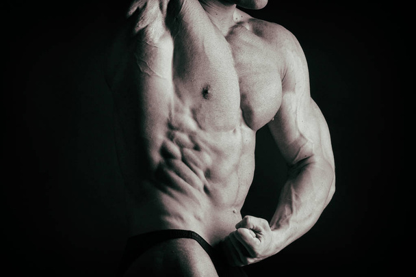 bodybuilder on a dark background. - Фото, зображення