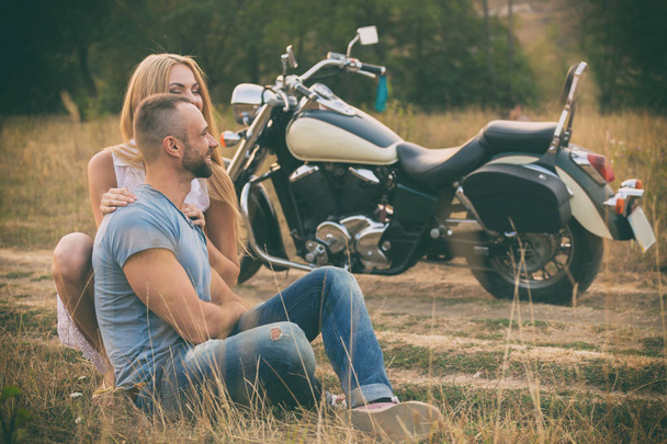 Travel and love, passion, bike road. Couple in love on the road with a motorcycle. Boy and girl in love. - Foto, afbeelding