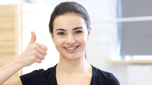 Thumbs Up by Young Woman, Portrait in Office - Foto, imagen