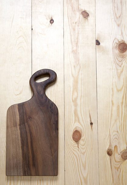 Cutting board on a wooden surface - Foto, Imagen