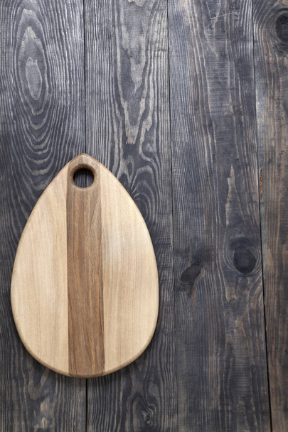 Cutting board on a wooden surface - Фото, изображение