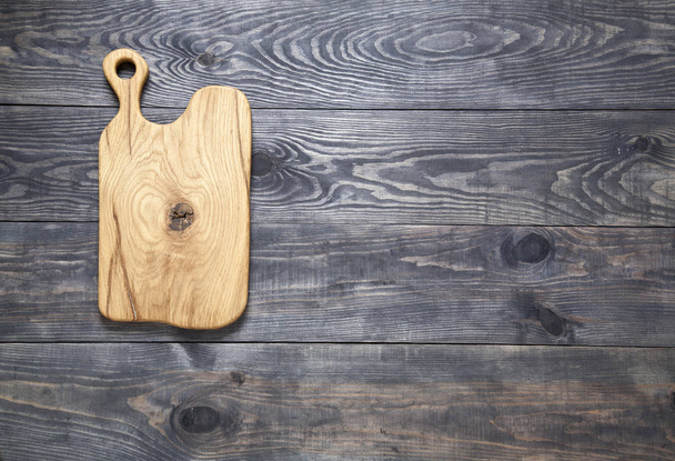 Cutting board on a wooden surface - Foto, imagen