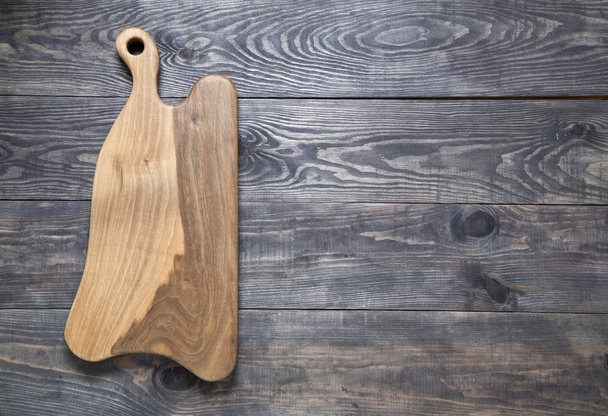 Cutting board on a wooden surface - Photo, image