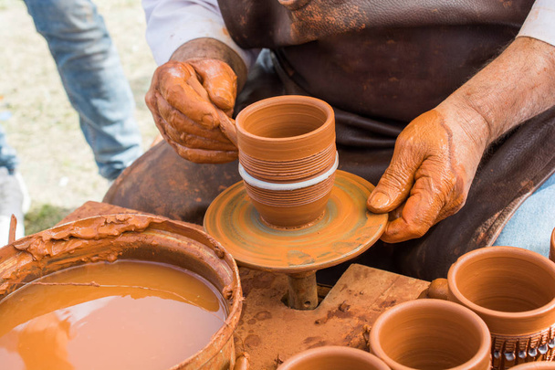 Potter`s hands shaping up the clay - Photo, Image