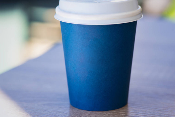 Just dark-blue paper cup of coffee or tea or another beverage inside, cup with place for your text - Photo, image