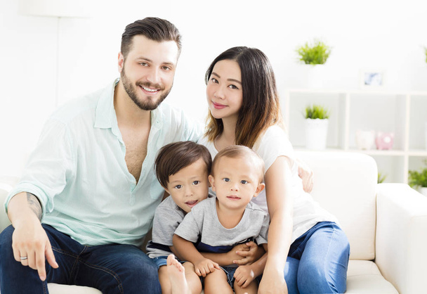 happy mixed race family in living room - Photo, Image