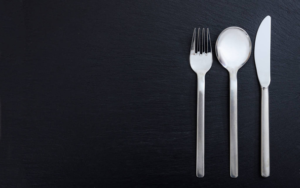 Cutlery isolated on black background - Foto, imagen