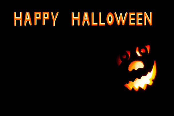 Happy Halloween pumpkin with scary face on black backgound - Fotó, kép