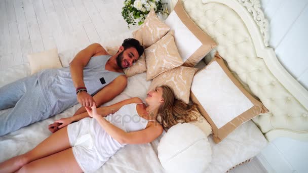 Lovers Fall Into Bed Forgetting About Everything in Bright Cozy Bedroom. - Video, Çekim