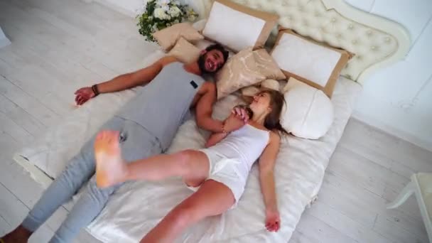 Lovers Man And Woman jump on Bed together - Footage, Video