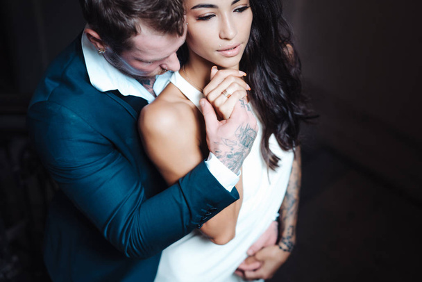 Beautiful, young couple posing on camera indoors - 写真・画像