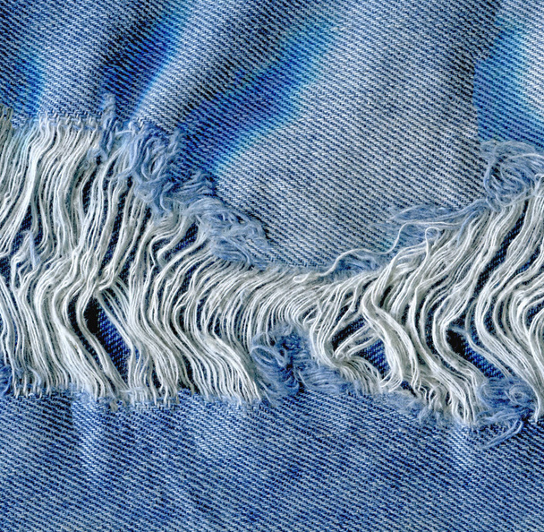 Vaqueros desgarrados textura de mezclilla. jeans vaqueros rasgados
 - Foto, imagen