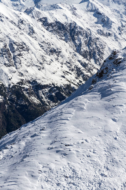 Rocky peaks in Caucasus mountains by winter covered by snow. - Φωτογραφία, εικόνα