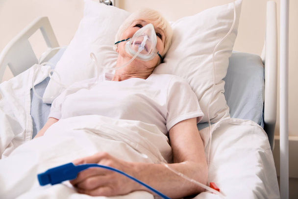 Ailing worried woman wearing life supporting devices - Φωτογραφία, εικόνα