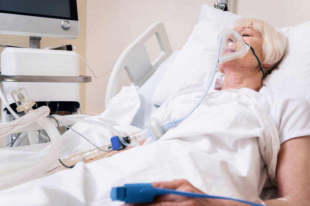 Weak ailing woman getting oxygen for recovery - Фото, зображення