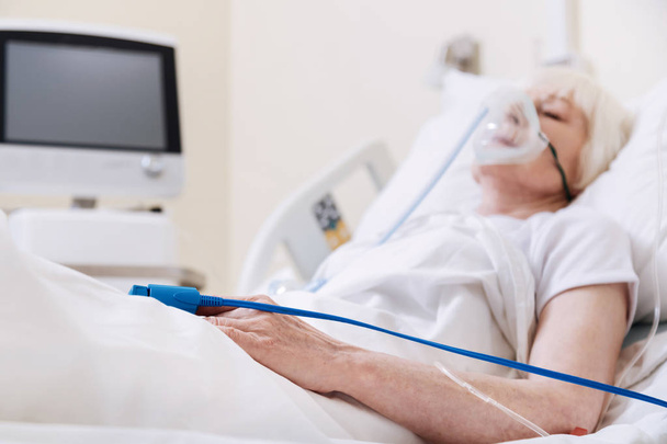 Unconscious tender aged woman getting better in hospital - Fotografie, Obrázek