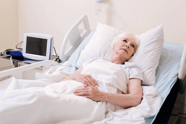 Vulnerable worried woman feeling lonely in hospital - Photo, Image