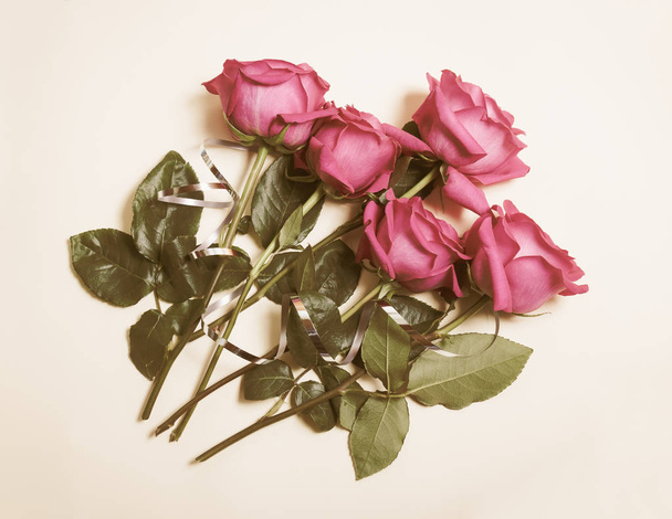 Beautiful roses on beige background. Vintage style - Photo, Image