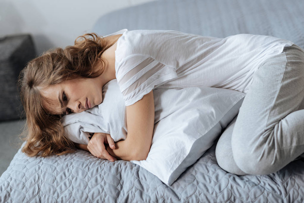 Mujer deprimida triste acostada en la cama
 - Foto, Imagen