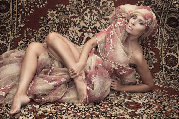 Portrait of a girl model on the background of carpets. Asian cul - Foto, Imagem