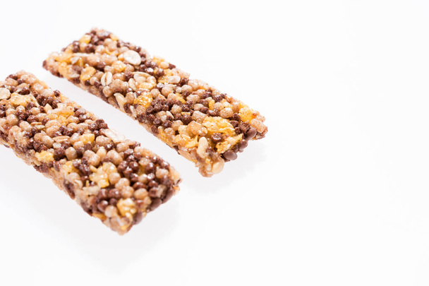 Two healthy granola bar (muesli or cereal bar) isolated on white - Фото, изображение