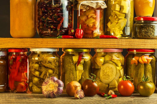Jars with variety of pickled vegetables. Carrots, field garlic, parsley in glas. Preserved food. Fermented preserved vegetarian food concept. - Foto, Bild